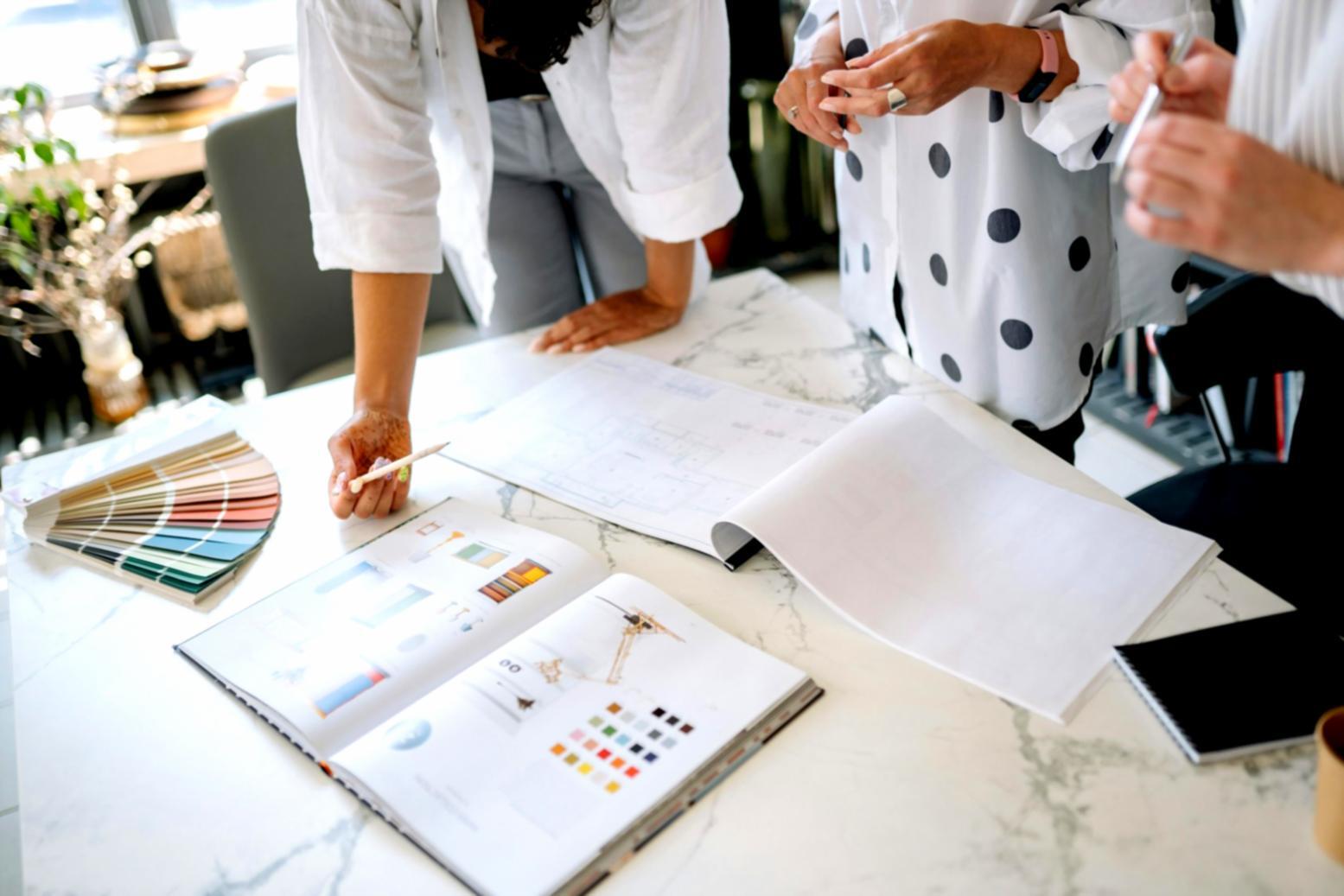 Professional celebration planning workspace with creative materials and design elements